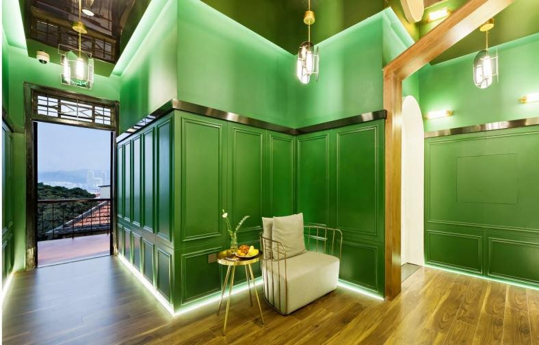 Gulangyu (Kulangsu) Xiamen Hotel Gallery-Green Interior Stylish green - themed interior space in a Gulangyu (Kulangsu) Xiamen hotel, featuring a cozy chair, side table, and outdoor view access